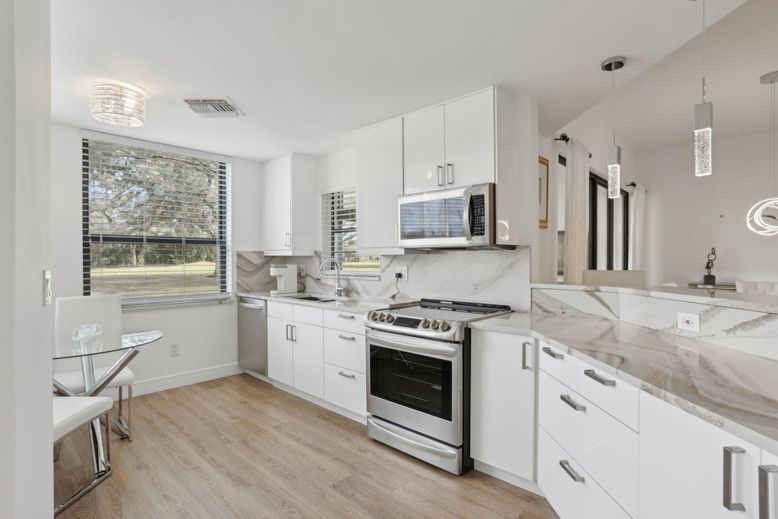 Interior, Kitchen, Marble Walls, Pendant Lights, Stainless Steel Appliances, Wood Texture Flooring