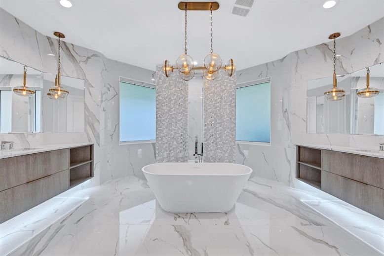 Bathroom, Dual Sink Vanities, Free Standing Baths, Interior, Marble, Marble Walls, Pendant Lights, Recessed Lighting
