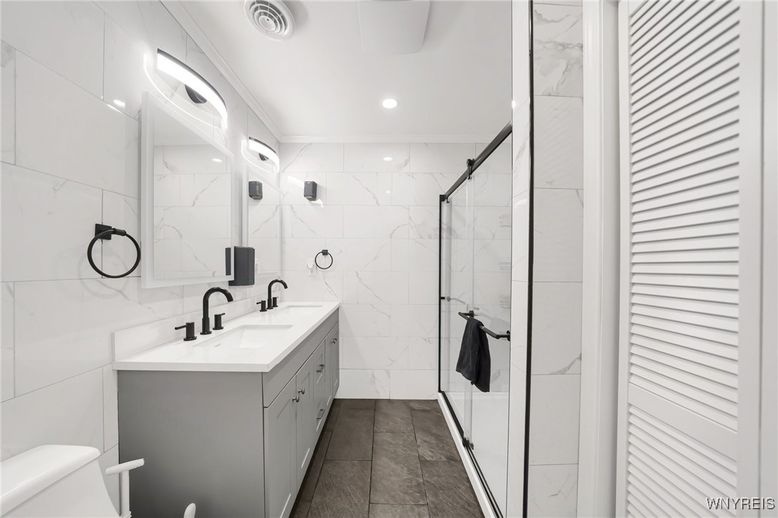 Bathroom, Dual Sink Vanities, Glass Shower, Interior, Marble Walls, Recessed Lighting