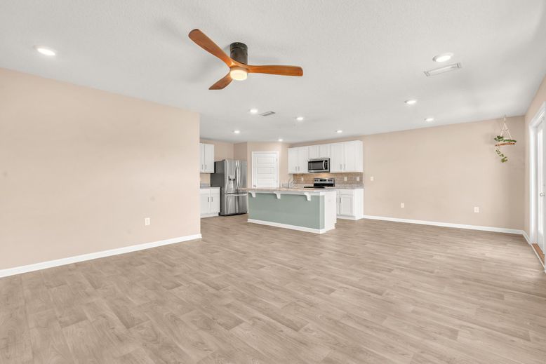 Empty room, Interior, Kitchen, Recessed Lighting, Stainless Steel Appliances, Wood Texture Flooring