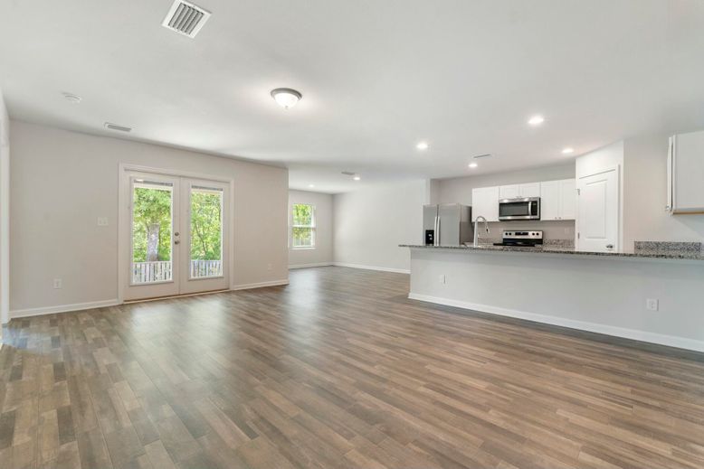 Empty room, Interior, Kitchen, Recessed Lighting, Stainless Steel Appliances, Wood Texture Flooring
