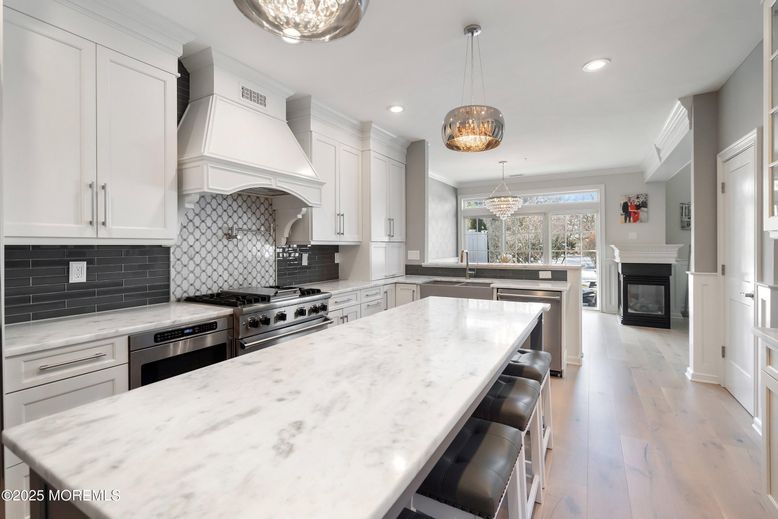 Chandelier, Fireplace, Interior, Kitchen, Pendant Lights, Recessed Lighting, Stainless Steel Appliances, Wood Texture Flooring