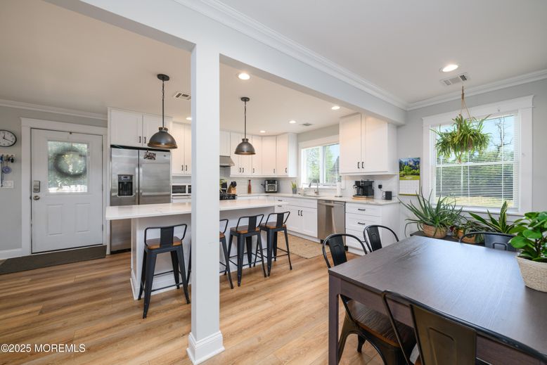 Dining room, Interior, Kitchen, Pendant Lights, Recessed Lighting, Stainless Steel Appliances, Wood Texture Flooring