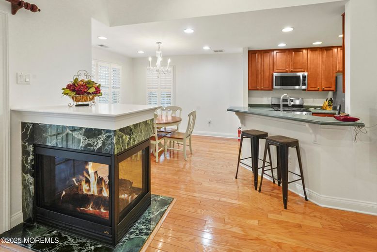 Chandelier, Dining room, Fireplace, Interior, Kitchen, Recessed Lighting, Stainless Steel Appliances, Wood Texture Flooring
