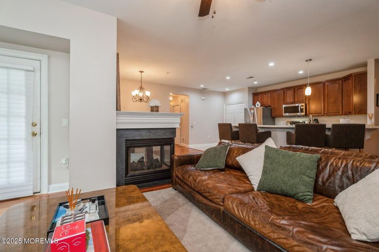 Chandelier, Dining room, Fireplace, Interior, Kitchen, Living room, Pendant Lights, Recessed Lighting, Stainless Steel Appliances