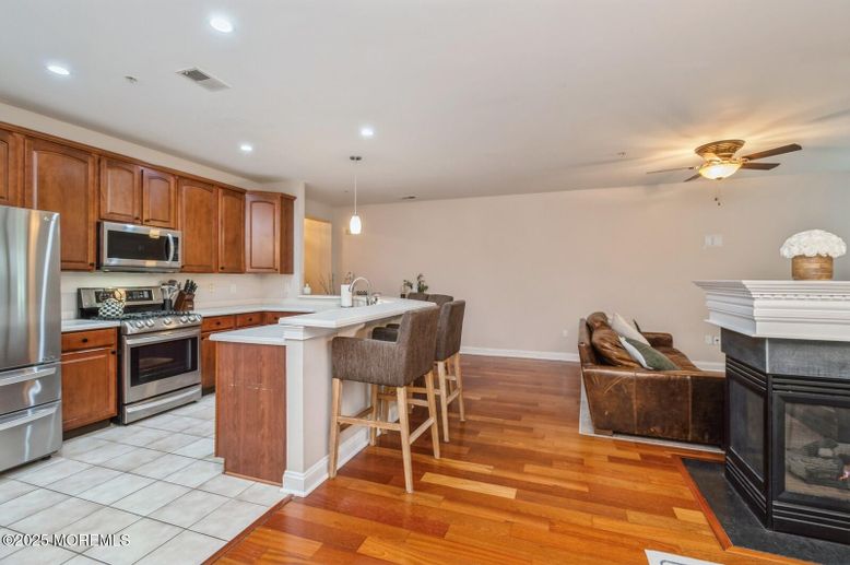 Fireplace, Interior, Kitchen, Pendant Lights, Recessed Lighting, Stainless Steel Appliances, Wood Texture Flooring