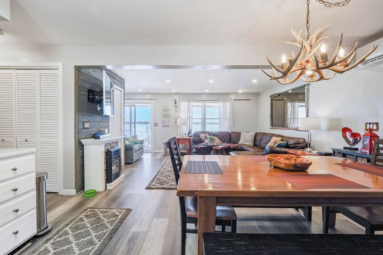 Chandelier, Dining room, Fireplace, Interior, Living room, Recessed Lighting, Stone Walls, Wood Texture Flooring