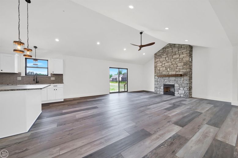 Empty room, Fireplace, Interior, Kitchen, Pendant Lights, Recessed Lighting, Stone Walls, Wood Texture Flooring
