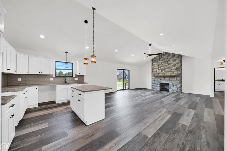 Empty room, Fireplace, Interior, Kitchen, Pendant Lights, Recessed Lighting, Stone Walls, Wood Texture Flooring