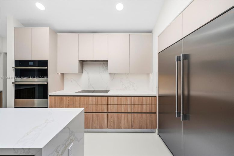 Interior, Kitchen, Marble Walls, Recessed Lighting, Stainless Steel Appliances