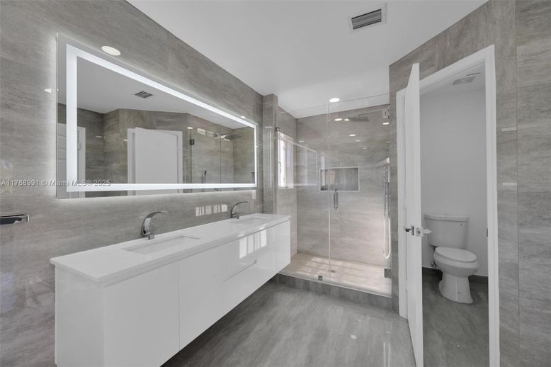 Bathroom, Dual Sink Vanities, Glass Shower, Interior, Recessed Lighting, Wood Texture Flooring
