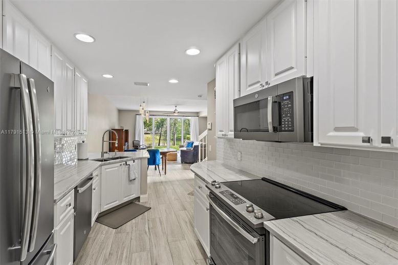 Dining room, Interior, Kitchen, Recessed Lighting, Stainless Steel Appliances, Wood Texture Flooring