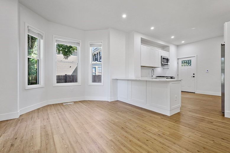 Empty room, Interior, Kitchen, Recessed Lighting, Stainless Steel Appliances, Wood Texture Flooring