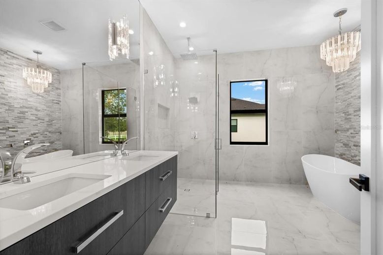 Bathroom, Chandelier, Dual Sink Vanities, Free Standing Baths, Glass Shower, Interior, Marble, Marble Walls, Recessed Lighting