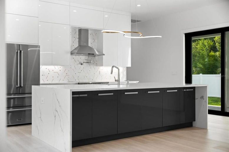 Interior, Kitchen, Marble Walls, Pendant Lights, Recessed Lighting, Stainless Steel Appliances, Wood Texture Flooring