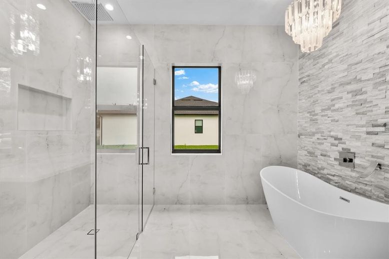 Bathroom, Chandelier, Free Standing Baths, Glass Shower, Interior, Marble, Marble Walls, Recessed Lighting