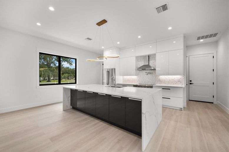 Interior, Kitchen, Marble Walls, Pendant Lights, Recessed Lighting, Stainless Steel Appliances, Wood Texture Flooring