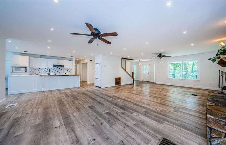 Empty room, Interior, Kitchen, Recessed Lighting, Stainless Steel Appliances, Wood Texture Flooring