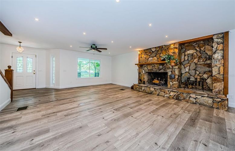 Empty room, Fireplace, Interior, Recessed Lighting, Stone Walls, Wood Texture Flooring