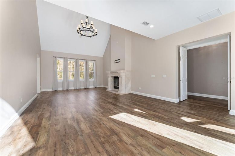 Chandelier, Empty room, Fireplace, Interior, Recessed Lighting, Wood Texture Flooring