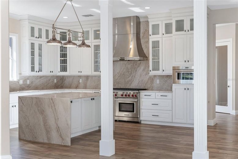 Interior, Kitchen, Marble Walls, Pendant Lights, Recessed Lighting, Stainless Steel Appliances, Wood Texture Flooring