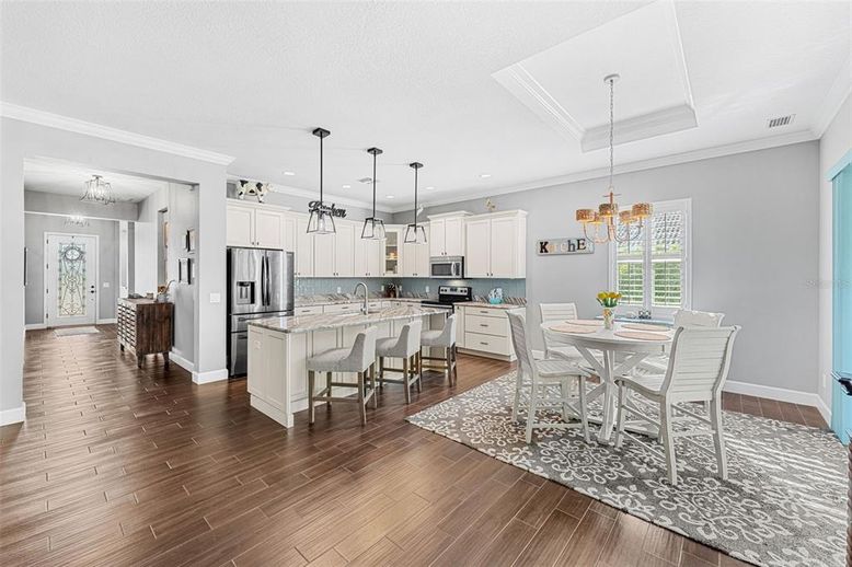 Chandelier, Dining room, Interior, Kitchen, Pendant Lights, Recessed Lighting, Stainless Steel Appliances, Wood Texture Flooring