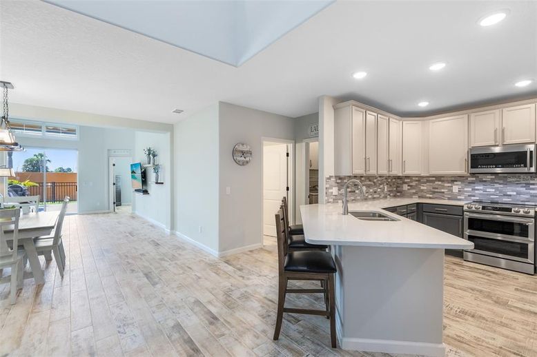 Dining room, Interior, Kitchen, Pendant Lights, Recessed Lighting, Stainless Steel Appliances, Wood Texture Flooring
