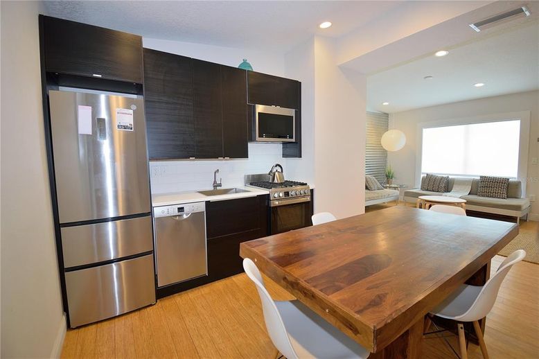 Dining room, Interior, Kitchen, Living room, Recessed Lighting, Stainless Steel Appliances, Wood Texture Flooring
