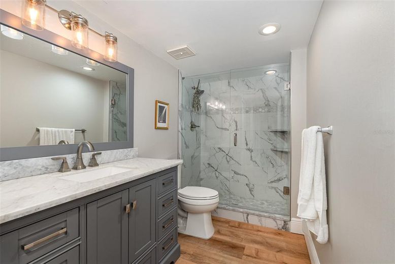 Bathroom, Glass Shower, Interior, Marble Walls, Recessed Lighting, Wood Texture Flooring