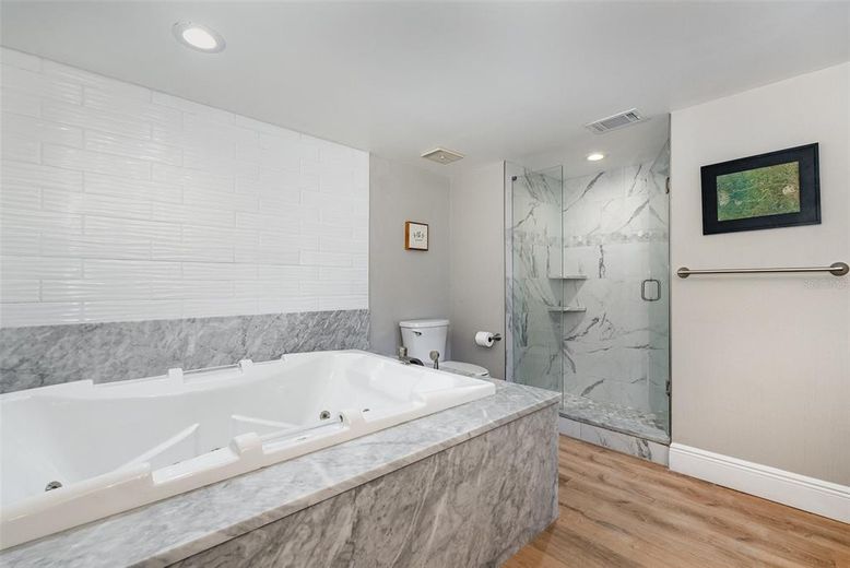 Bathroom, Glass Shower, Interior, Marble Walls, Recessed Lighting, Wood Texture Flooring
