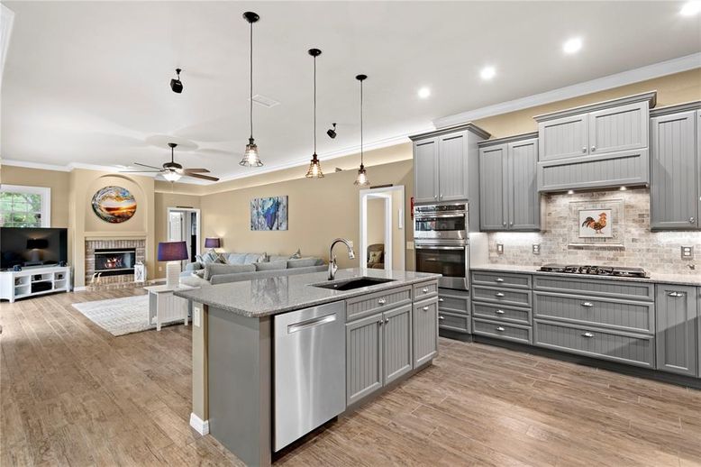 Fireplace, Interior, Kitchen, Living room, Pendant Lights, Recessed Lighting, Stainless Steel Appliances, Wood Texture Flooring
