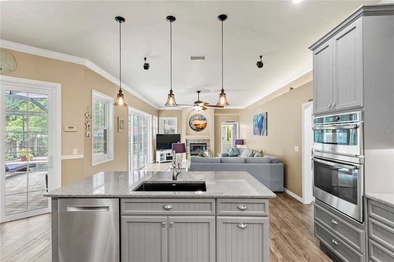Fireplace, Interior, Kitchen, Living room, Pendant Lights, Recessed Lighting, Stainless Steel Appliances, Wood Texture Flooring