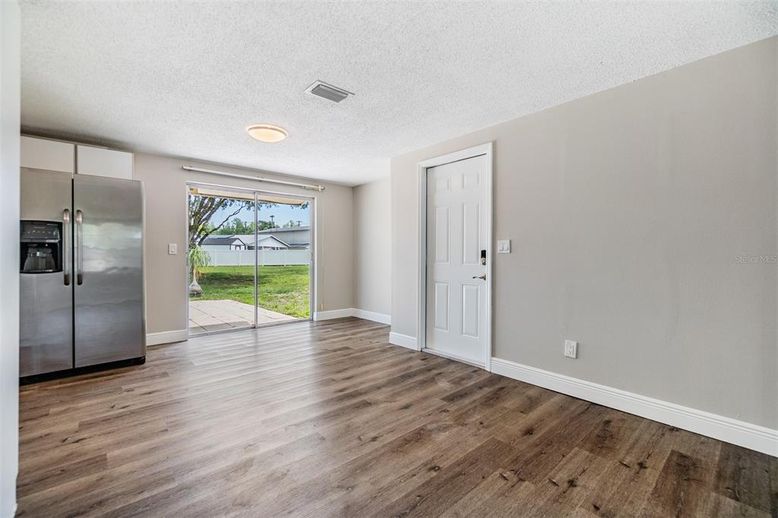 Empty room, Interior, Kitchen, Recessed Lighting, Stainless Steel Appliances, Wood Texture Flooring