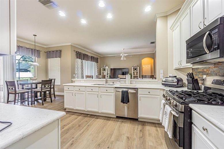 Dining room, Interior, Kitchen, Pendant Lights, Recessed Lighting, Stainless Steel Appliances, Wood Texture Flooring