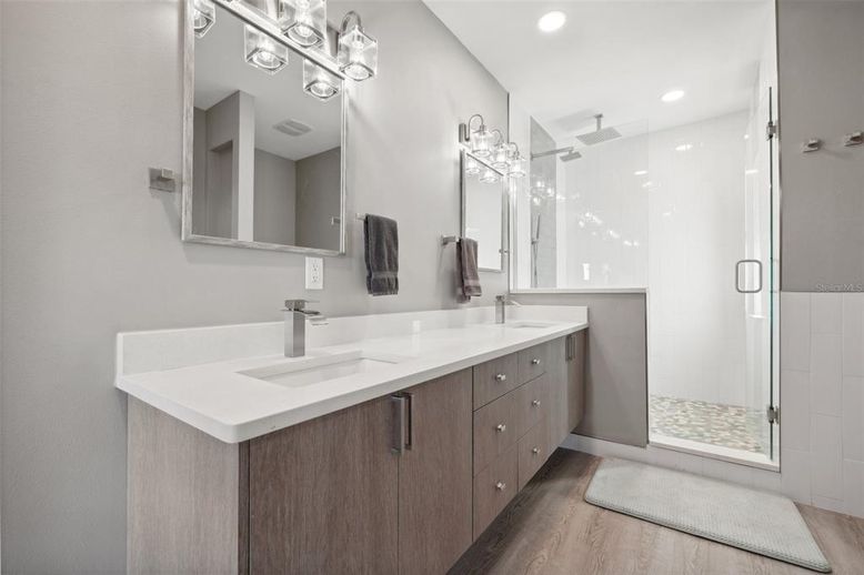 Bathroom, Dual Sink Vanities, Glass Shower, Interior, Recessed Lighting, Wood Texture Flooring