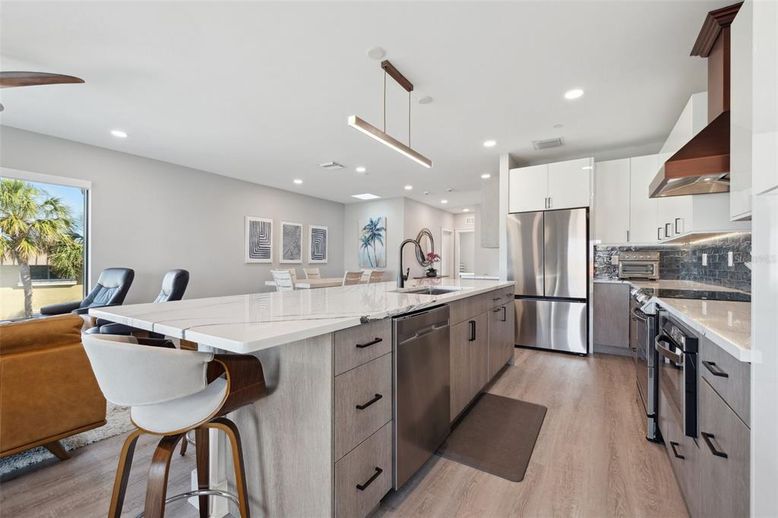 Dining room, Interior, Kitchen, Pendant Lights, Recessed Lighting, Stainless Steel Appliances, Wood Texture Flooring