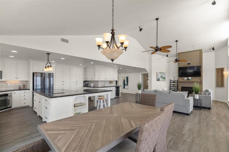Chandelier, Dining room, Fireplace, Interior, Kitchen, Living room, Pendant Lights, Recessed Lighting, Stainless Steel Appliances, Wood Texture Flooring