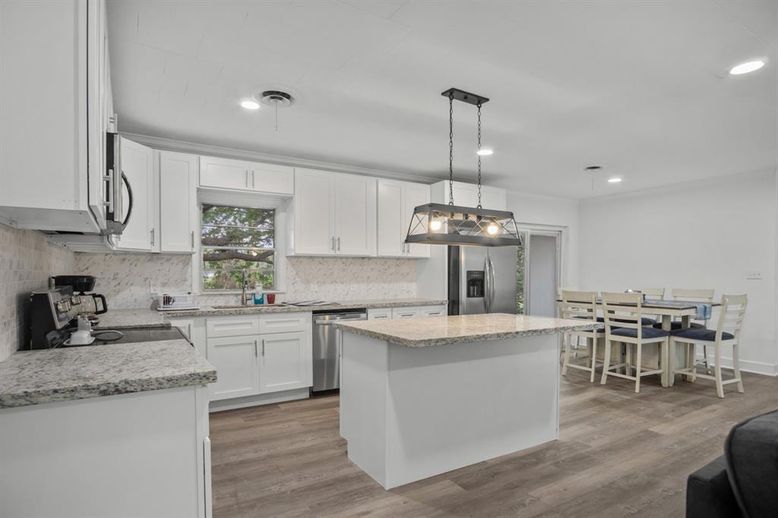 Dining room, Interior, Kitchen, Pendant Lights, Recessed Lighting, Stainless Steel Appliances, Wood Texture Flooring