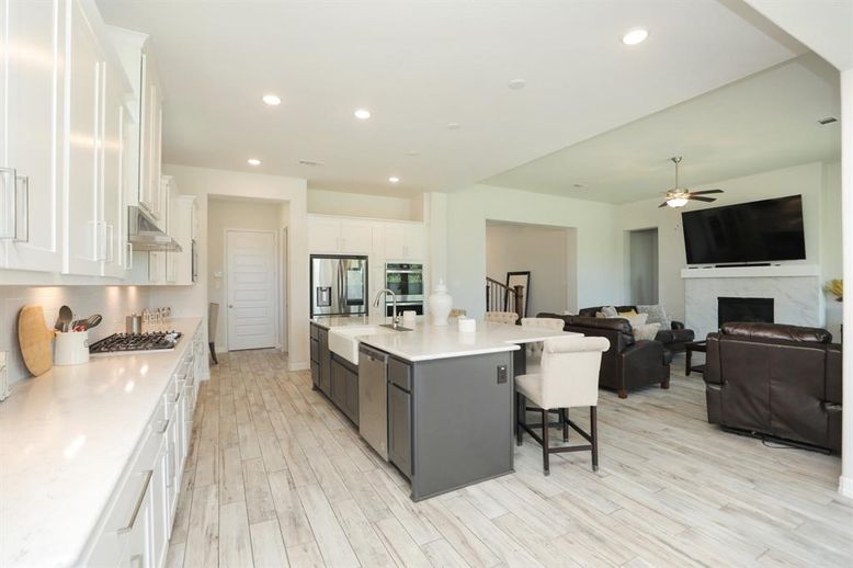 Fireplace, Interior, Kitchen, Living room, Recessed Lighting, Stainless Steel Appliances, Wood Texture Flooring