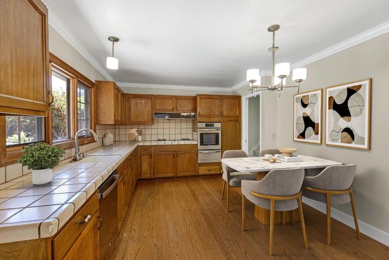 Chandelier, Dining room, Interior, Kitchen, Pendant Lights, Stainless Steel Appliances, Tile Countertops, Wood Texture Flooring
