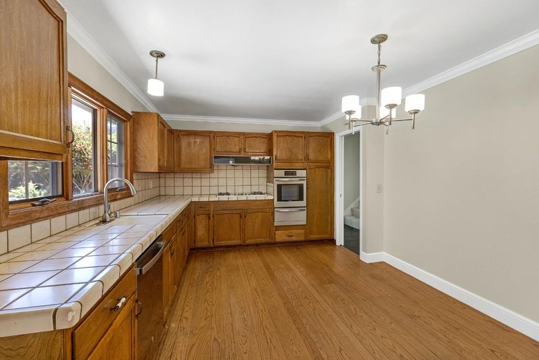 Chandelier, Interior, Kitchen, Pendant Lights, Stainless Steel Appliances, Tile Countertops, Wood Texture Flooring
