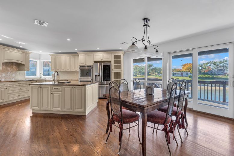 Chandelier, Dining room, Interior, Kitchen, Recessed Lighting, Stainless Steel Appliances, Wood Texture Flooring