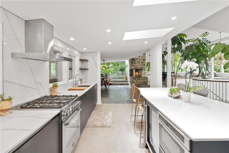 Fireplace, Interior, Kitchen, Marble Walls, Recessed Lighting, Stainless Steel Appliances, Stone Walls