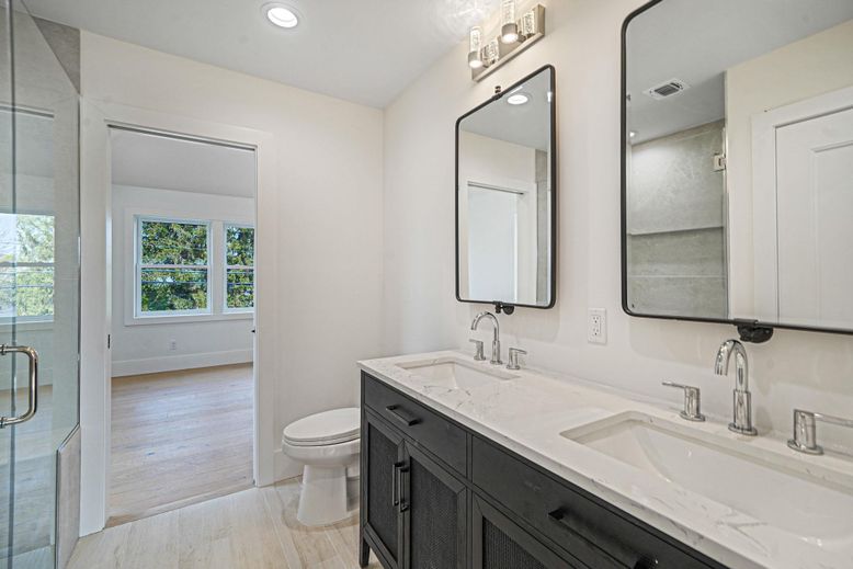 Bathroom, Dual Sink Vanities, Glass Shower, Interior, Recessed Lighting, Wood Texture Flooring