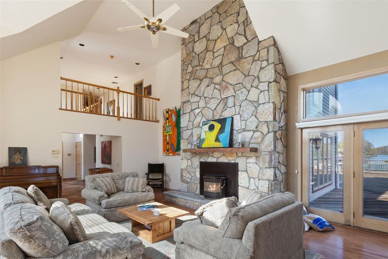 Fireplace, Interior, Living room, Recessed Lighting, Stone Walls, Wood Texture Flooring