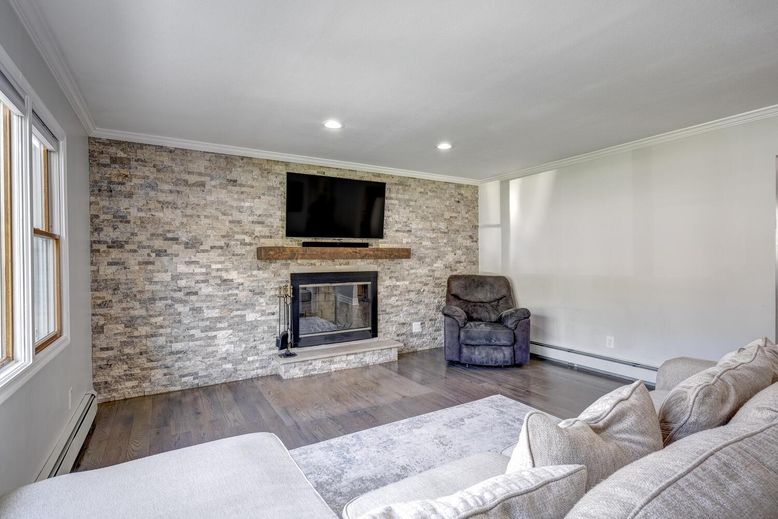 Fireplace, Interior, Living room, Recessed Lighting, Stone Walls, Wood Texture Flooring