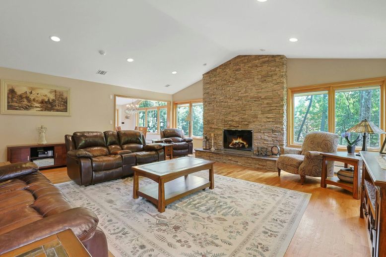 Fireplace, Interior, Living room, Recessed Lighting, Stone Walls, Wood Texture Flooring