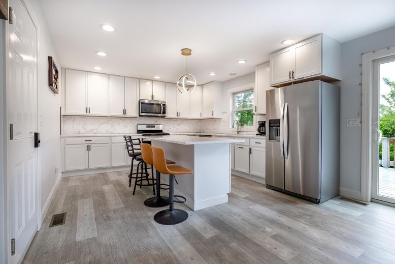 Interior, Kitchen, Marble Walls, Pendant Lights, Recessed Lighting, Stainless Steel Appliances, Wood Texture Flooring