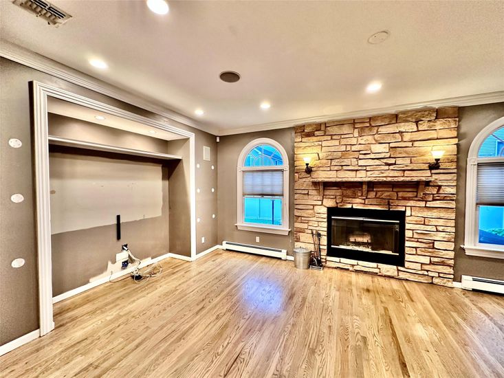 Empty room, Fireplace, Interior, Recessed Lighting, Stone Walls, Wood Texture Flooring