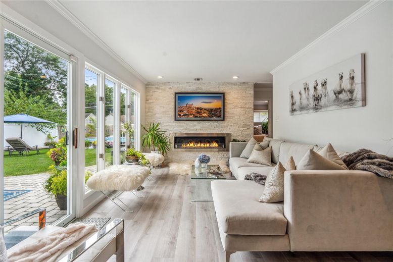 Fireplace, Interior, Living room, Recessed Lighting, Stone Walls, Wood Texture Flooring
